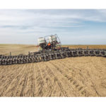 The vertical contouring toolbar flexes up and down as much as 66 inches to follow the contour of the field and ensure the row units properly engage with the soil. The sensor-controlled hydraulic system monitors the angle of the row-unit parallel arms to automatically adjust toolbar height. | Agco photo