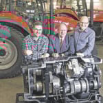 Young's Equipment recently made a $470,000 in-kind gift to the Saskatchewan Polytechnic agriculture equipment technician program. From left are Morgan Kuntz, first-year student in the program. Tim Young, owner of Young's Equipment and Chris Thomson, director of the ag equipment technician program. The three are leaning on a CVT transmission, which was part of the donation. | William DeKay photo
