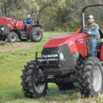 The new Farmall A series tractors come standard with a 12x12 clutch-less power shuttle transmission. Cab models have a high-visibility roof panel allowing the operator to perform loader tasks such as stacking big bales. | Case IH photo