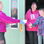 Kate Horsman delivers free lunch to the isolated Poelen family as part of a program launched by the Indian Head Bakery in Indian Head, Sask. | Christalee Froese photo