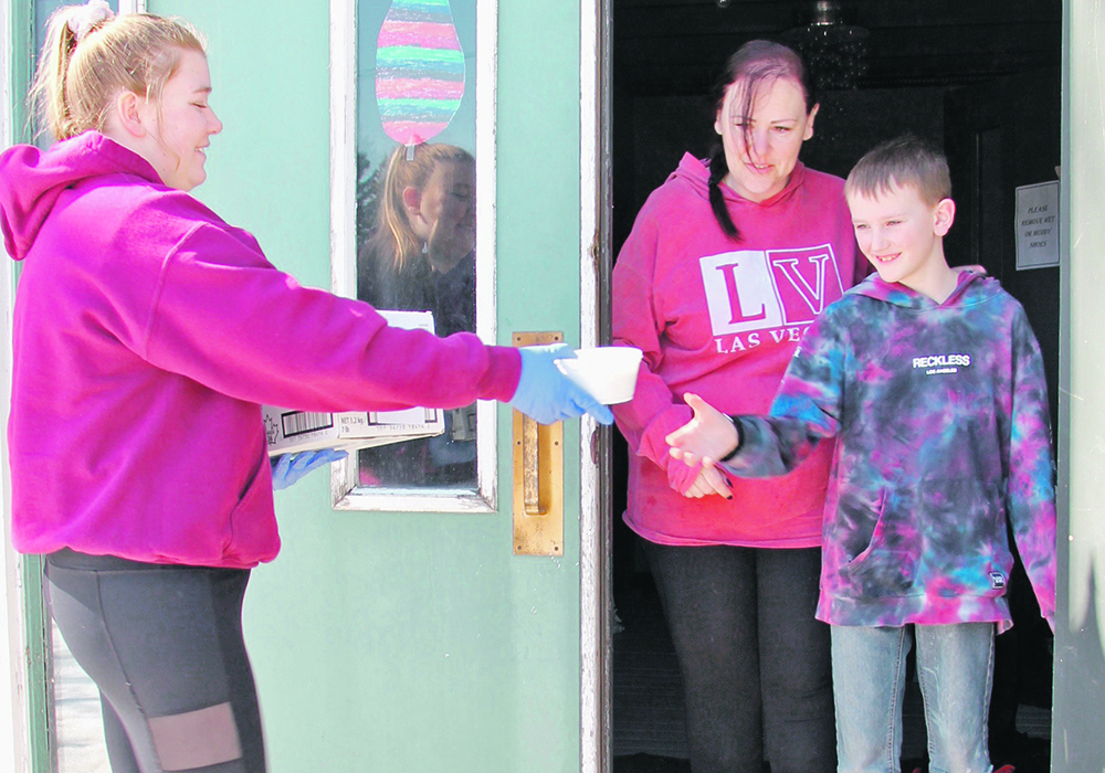 Kate Horsman delivers free lunch to the isolated Poelen family as part of a program launched by the Indian Head Bakery in Indian Head, Sask.  |  Christalee Froese photo