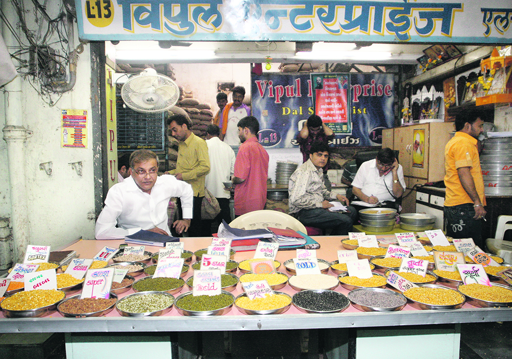 Brokers at the Mumbai Market display samples of rice, wheat and pulses on offer. Wholesale customers stop buy and examine the quality and price of pulses on offer at the market.  |  WP file photo