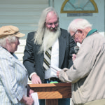 Baptist Pastor Carson Cole with John and Winnie Anderson in front of the Westlock Baptist church, renewing their marriage vows 70 years later. | Les Dunford photo