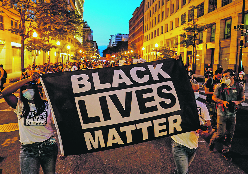 Protesters hold up a Black Lives Matter banner as they march during a demonstration against racial inequality in Washington, D.C., earlier this month. The turmoil seen in the United States and around the world may seem far removed from the Prairies, but people of colour say they also experience racism in rural Canada.  |  Reuters/Erin Scott photo