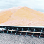Once the pile is securely tarped, the negative pressure fan sucks air out of the grain while louvres in the walls allow atmospheric air into the pile. With electrical and base work included, the system costs about 40 cents per bushel to store grain for one year. | GSI photo