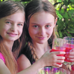Olivia, left, and Keira Deobald enjoy raspberry lemonade on a hot summer day. | Leanne Deobald photo
