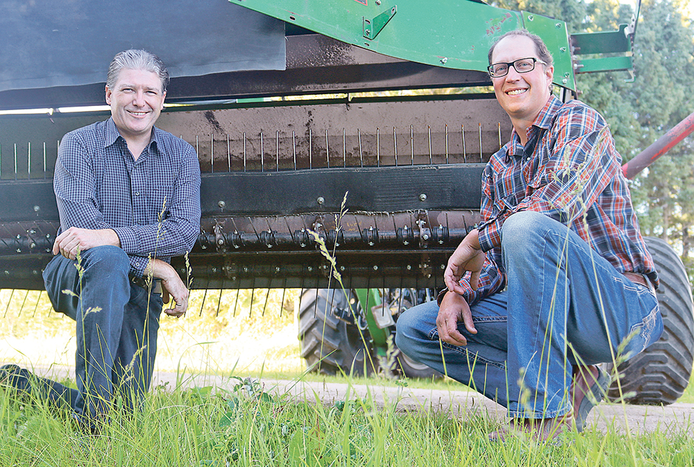 Ben Voss, left, and farmer and inventor Ryan Sommerfeld have found a way to fluff up hay and crop windrows for quicker drying with only a minimum of leaf or grain loss. The first factory-built Aerows will be available late this summer. MSRP ranges from  $23,900 to $29,500 depending on options. Aerow requires  a minimum of 50 horsepower and 15 g.p.m. hydraulic flow.  |  Aerow Manufacturing photo