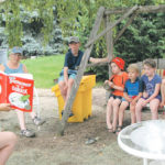 Anna Cressman reads Bartholomew and the Oobleck to her sons and their cousins after they all had fun mixing up and playing with oobleck. | Betty Ann Deobald photo