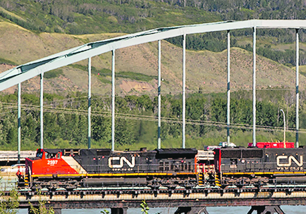 A CN train makes its way westward  across the rail bridge spanning the Peace River in the town of Peace River on August 5.  |  Randy Vanderveen photo