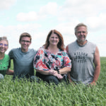 Paige, Luke, Teri and Scott Ruecker kneel in one of their 2020 oat crops. The family is growing oats certified for the gluten-free market. | Karen Briere photo