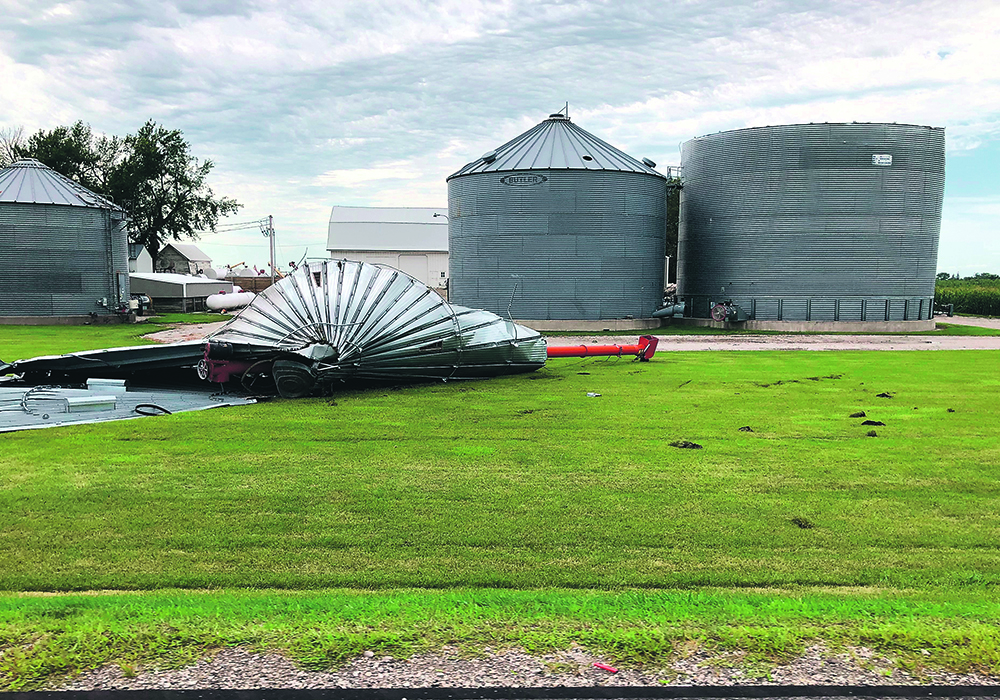 A grain bin damaged by the derecho, a fierce wind that swept through central Iowa Aug. 10, lies in a farmyard. |  USDA/Jeremy Davis photo