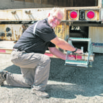 The step folds out of the way, on it’s own if it comes into contact with a dock. The steps provide safe access to decks or vans, says Brian Olson of PowerPin. | PowerPin photo