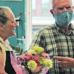 Ed Saffin of Cranbrook brings flowers to Laura Young, his favourite Kootenay Farm-to-Folk employee. | Christalee Froese photo