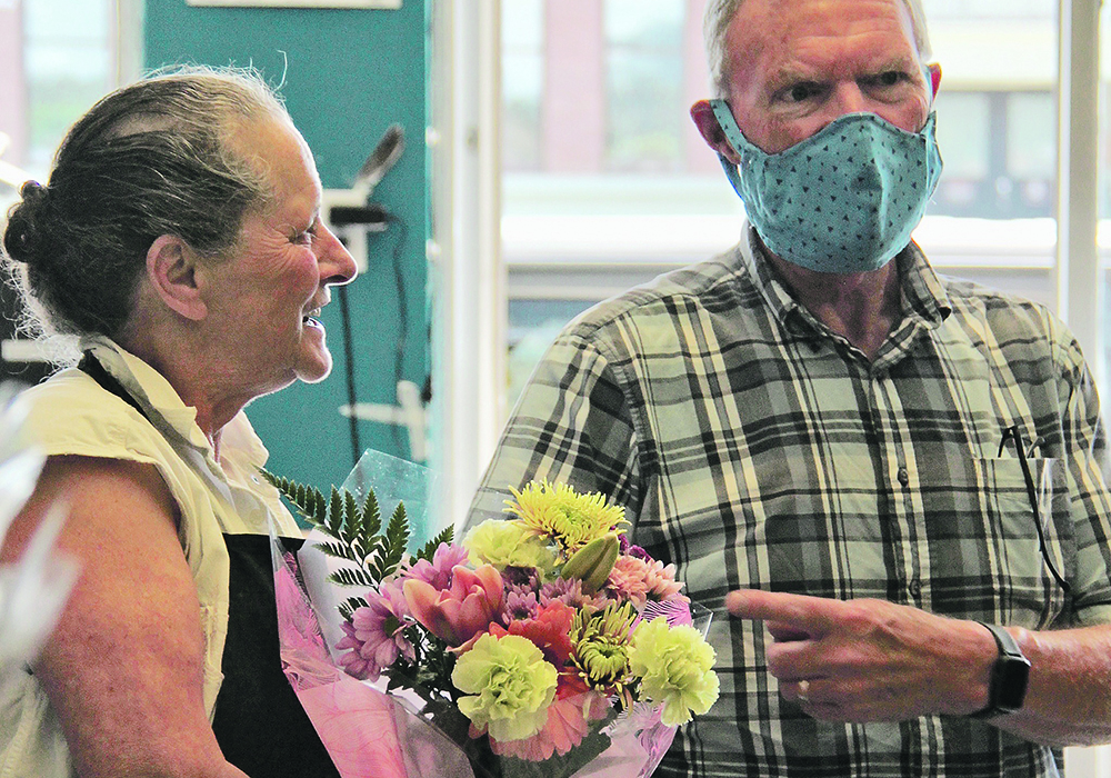 Ed Saffin of Cranbrook brings flowers to Laura Young, his favourite Kootenay Farm-to-Folk employee.  |  Christalee Froese photo
