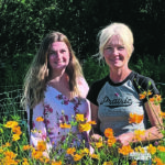 Jodi Friesen, right, and her daughter-in-law, Victoria, in the garden at Miss Millie’s Flower Farm near Poplar Point, Man. | Andrea Geary photo