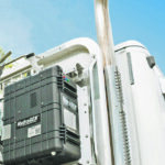 The cab-mounted suitcase can reduce fuel consumption by 20 percent on this over-the-road tractor. The HydraGEN box contains equipment to convert distilled water into pure hydrogen and pure oxygen, which are then directed into the air intake, where they create a cleaner burn. | Dynacert photo