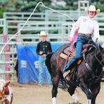 Taylor Broderson of Fort MacLeod, Alta., lets go of the rope after successfully roping her calf in the breakaway roping event. | Mike Sturk photo