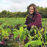 Kerri Giesbrecht kneels beside a row of colourful chard in her U-pick garden near Bawlf, Alta. | Mary MacArthur photo