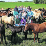 The King family of Corning, Sask., have been raising award-winning quarter horses for more than half a century. Four generations of the family are surrounded by some of their mares and foals at their Diamond K ranch. | William DeKay photo