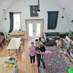 A bedroom built in the high loft area of the renovated barn looks down at Katie Hartfeil, Adam Turnbull and their daughter, Betty, in the main floor loft area. | Mary MacArthur photo