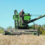 Brent Sterling combines wheat with his (by today’s standards) very small John Deere 45 combine with 10 foot cut header. | Les Dunford photo