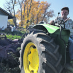 Jim Van Wert uses his 1960s-era John Deere to pull the 1940s potato digger. | Maxine Abraham photo