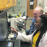 Professor David Miller discusses data with a member of his team. | University of Illinois photo