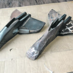 The opener on the right was hard surfaced on the nose and wings ran for 160 acres, was hard surfaced again and after 160 acres is too worn to fix, as the tip no longer digs into the soil and wings are worn thin. At left, Ferobide tiles have protected the wings and nose for 1,500 acres. | Huber Ag Equipment
