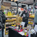 Red Deer residents Gordon and Lori Steppler buy items from Nixon Honey, manned by Brenda and Craig Nixon. | Maria Johnson photo