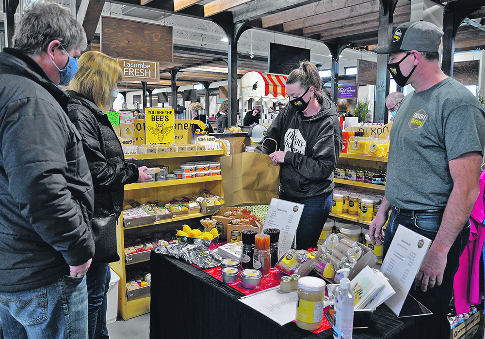 Red Deer residents Gordon and Lori Steppler buy items from Nixon Honey, manned by Brenda and Craig Nixon. | Maria Johnson photo