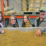 Gabby, left, Corrie, Charlotte and Dave Fisher manufacture and sell straw pellets from their farm near Blackie, Alta. | Janet Kanters photo