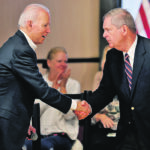 Former Iowa governor Tom Vilsack, right, who sources say will be the next agriculture secretary, shakes hands with president-elect Joe Biden in January when Biden was seeking the Democratic presidential nomination. | Reuters/Mike Segar photo