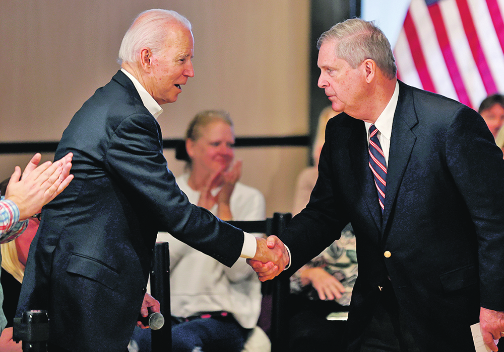 Former Iowa governor Tom Vilsack, right, who sources say will be the next agriculture secretary, shakes hands with president-elect Joe Biden in January when Biden was seeking the Democratic presidential nomination. | Reuters/Mike Segar photo