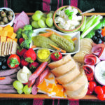 Charcuterie boards can make a fun family meal or be served as a creative appetizer. For a meat and cheese charcuterie board, think of the food your family likes and arrange it creatively on a board or serving tray. For a meal, add bread or sub buns. | Betty Ann Deobald photo