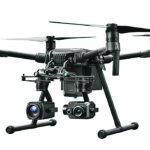 The DJI Matrice 200 series is a large drone that flies with two batteries on the back and has a FPV camera on the front that gives the pilot their position. It also has two gimbals attachments called sky ports where a multitude of different cameras can be attached. | DJI photo