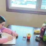Mia Mackie, 10, in grade 5, works on math at the kitchen table. | Kylie Mackie photo