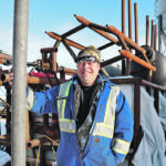 Danny Farkash of Vermilion stands beside his machine that turns agricultural plastic into fence posts. | Mary MacArthur photo
