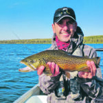 An Alberta Environment and Parks employee shows off a mature tiger trout caught in Lower Chain Lake. | Alberta Environment and Parks photo