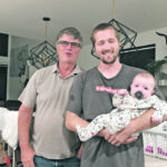 Wes, left, and Ian Froese, with baby Read, make up three generations of Froeses on the family farm near Boissevain, Man. Ian is gradually taking over the farm from his father. | Supplied photo