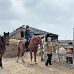 Aurora Farm founder and owner Louise May visits with riders at the farm. | Andrea Geary photo