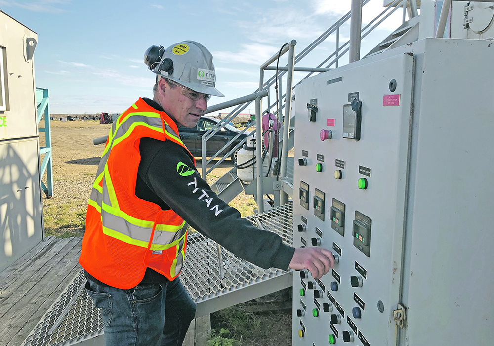 Jamie Bakos makes an adjustment at the pyrolysis facility near Craik, Sask. | Titan Clean Energy Solutions photo