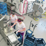 Wilma and Nicole Mol fill glass bottles with milk inside their dairy plant near Thunder Bay, Ont. The Mols operate Slate River Dairy and sell natural dairy products at their store and through a farmers market. | Photo courtesy of Cynthia Vis/Sunny Creek Photography