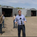 At a farm just north of Regina, agriculture critic Trent Wother-spoon and leader Ryan Meili said the recent threat of drought should have been enough for the Saskatchewan Party government to change its mind and agree to pay for the change. | Screencap via globalnews.ca