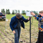 Olds College research team members install a Metos sensor at the college's Smart Farm. | Olds College photo