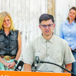 Alberta NDP leader Rachel Notley listens as Mikhail Ivanchikov,
president of Dandelion Renewables, talks about how producers
can convert farm buildings to net-zero energy. The event took
place in front of the 112-year-old former Stewart livery stable in
inner-city Inglewood in Calgary. | Photo supllied by Alberta NDP