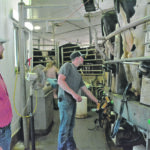 Parker and Quinton Weiss work at the carousel for the afternoon milking at Hatview Dairy. | Alex McCuaig photo