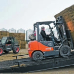 Merlis Wiebe and Daryl Bueckert unload and stack the first truckload of hay that arrived in Saskatchewan last week as part of Hay West. The hay was received at Wiebe’s farm near Osler, Sask., Sept. 10 as part of an effort to deliver hay from Ontario to drought-affected farmers in Saskatchewan. | William DeKay photo