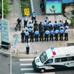 Police officers and security personnel gather outside the headquarters of China Evergrande Group in Shenzhen, Guangdong province, China, on Sept. 30, 2021. | Reuters/Aly Song photo