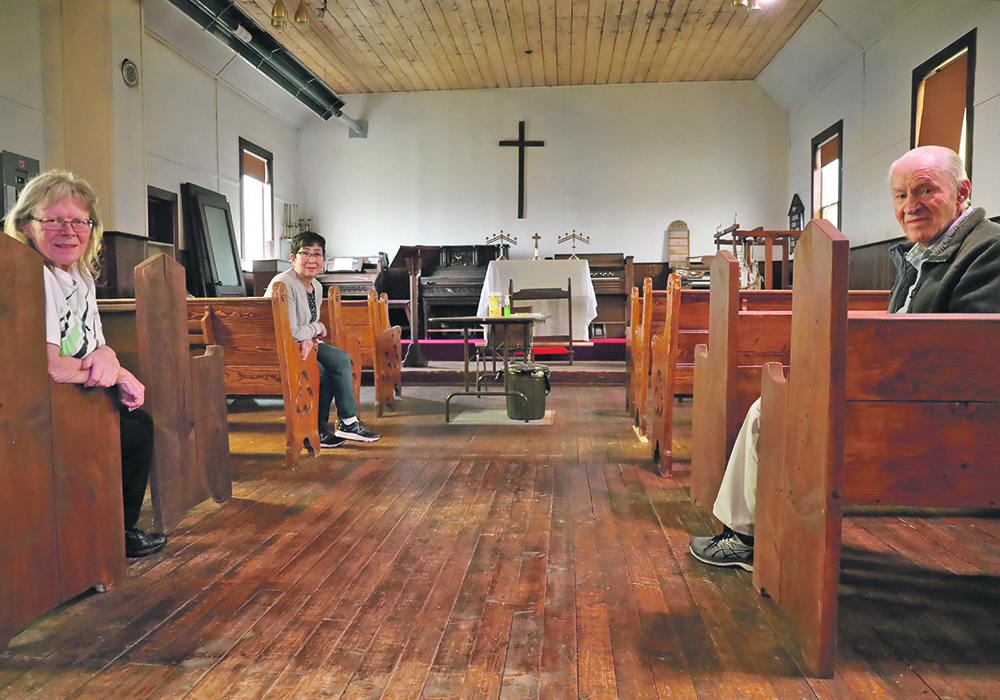 Pamela Schaub, Sandra Blades and Charlie Miner, volunteers with the Drayton Valley and District Historical Society sit in pews inside a historic Anglican Church donated to their museum. The society received $10,000 to refinish the floors of their church. The church is one of the main buildings on the museum site. Renovations were done earlier on the roof, ceiling and belfry.  |  Mary MacArthur photo