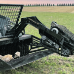 TerraClear is developing a robotic rock picker with the company’s TC80 Rock Picker bucket that has two opposing tracks on a hydraulic arm that pulls stones into the bucket. The automated platform is guided by a rock-locating computer program that uses drone imagery to find the big stones. | TerraClear photo